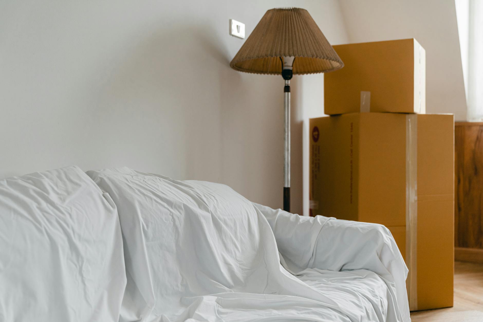 Furniture and packed boxes set down in a new home